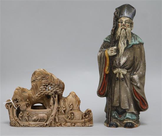 A Chinese soapstone carving of a river bank with figures, sampan and bullock and a terracotta figure of an Immortal (2)